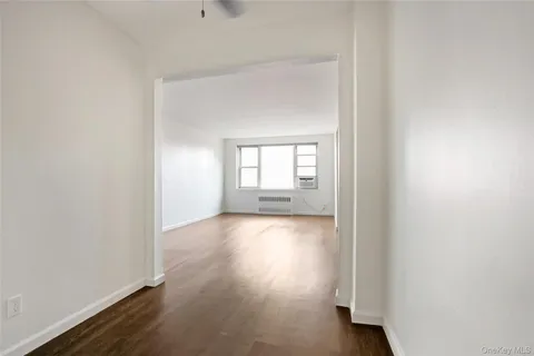 a view of wooden floor and windows in a room
