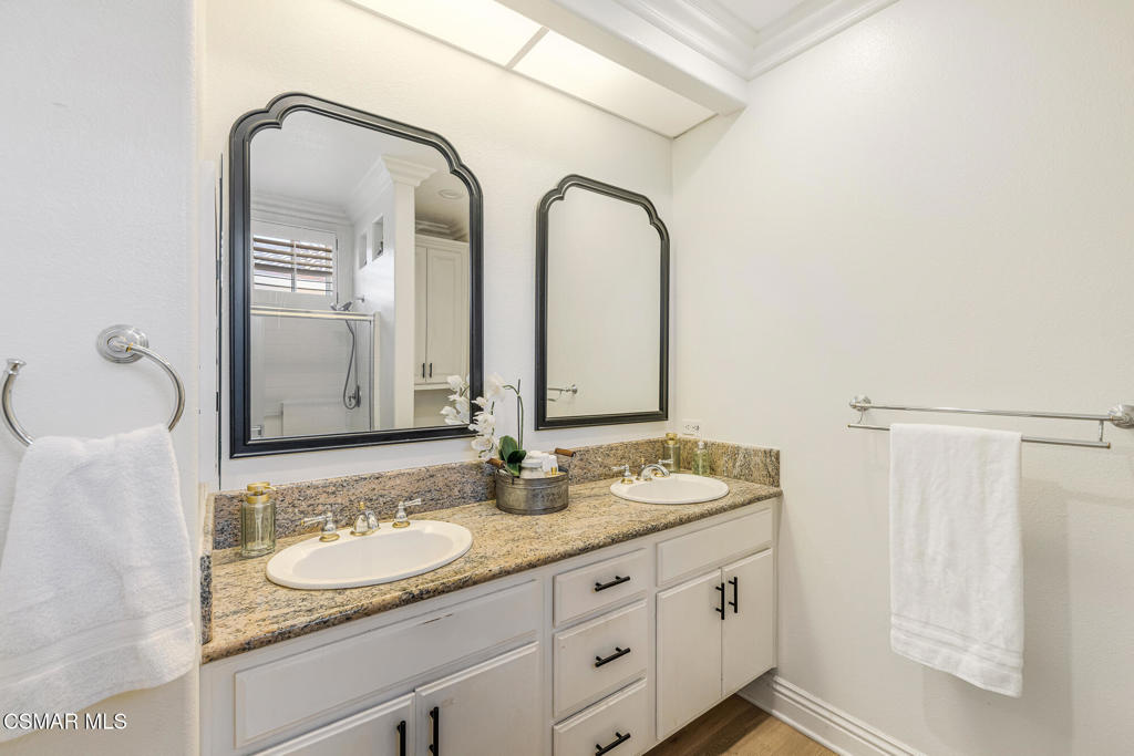 4038 Napoli Place Moorpark, CA 93021 - Photo 21 of 33 a bathroom with a granite countertop sink and a mirror