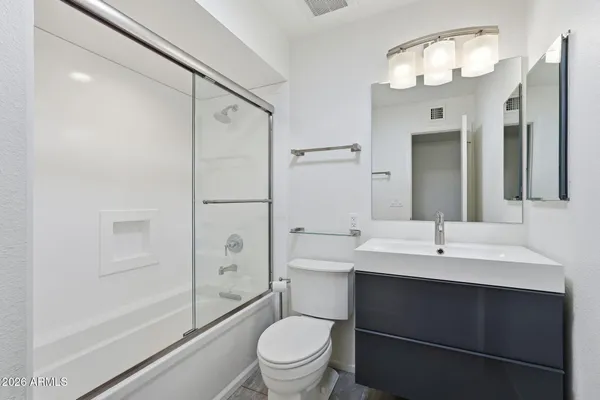 a view of a livingroom with a ceiling fan and window