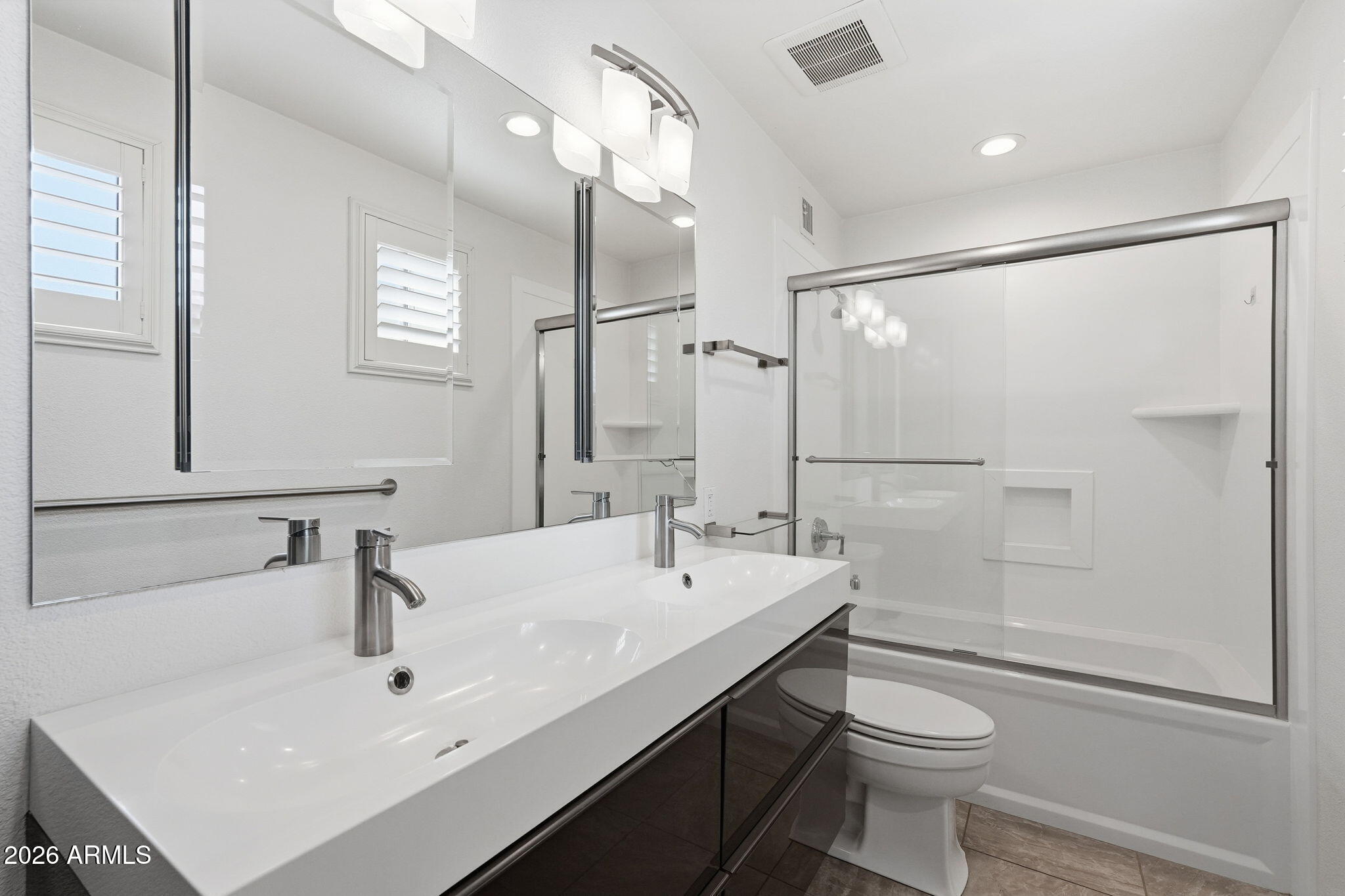 5352 South Country Club Way Tempe, AZ 85283 - Photo 19 of 42 a bathroom with a sink toilet a mirror and shower