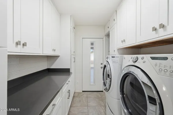 a front view of a house with a yard and a garage