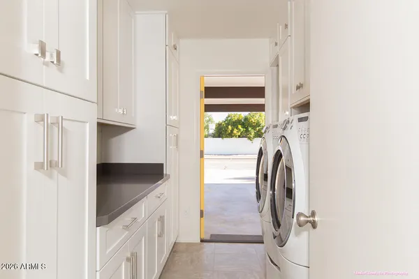 a kitchen with a sink and a washer dryer
