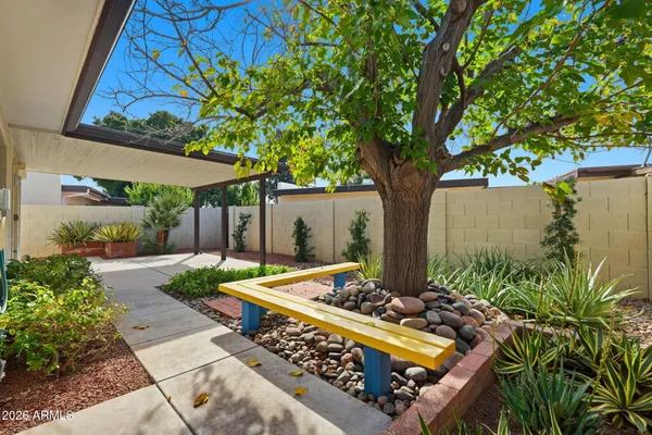 a view of backyard with a table and chair under an umbrella