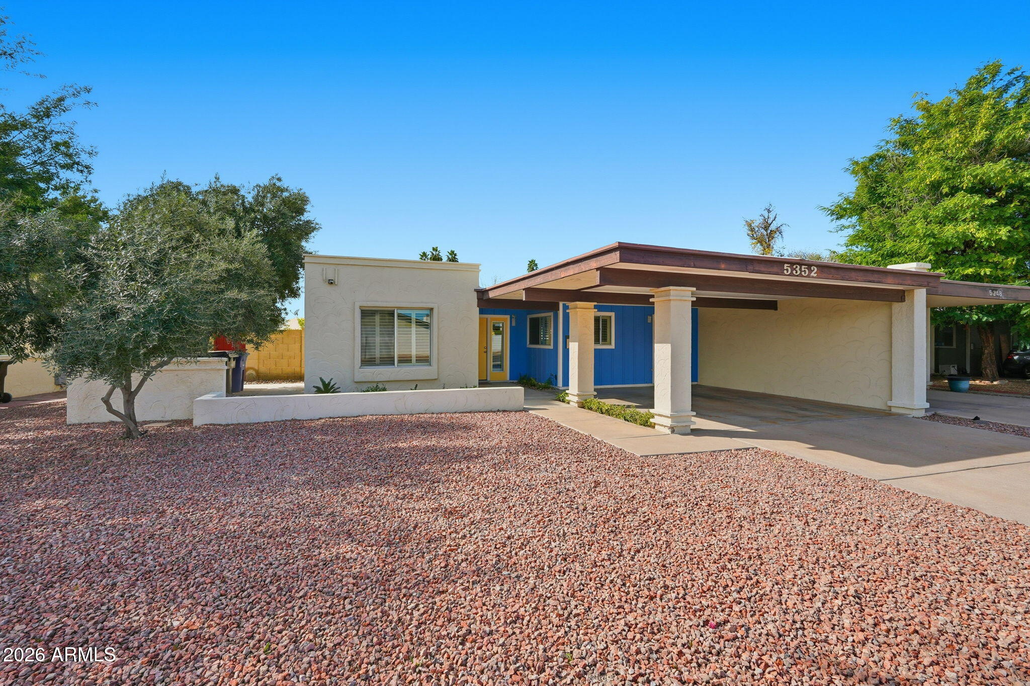 5352 South Country Club Way Tempe, AZ 85283 - Photo 41 of 42 a front view of a house with a yard and a garage
