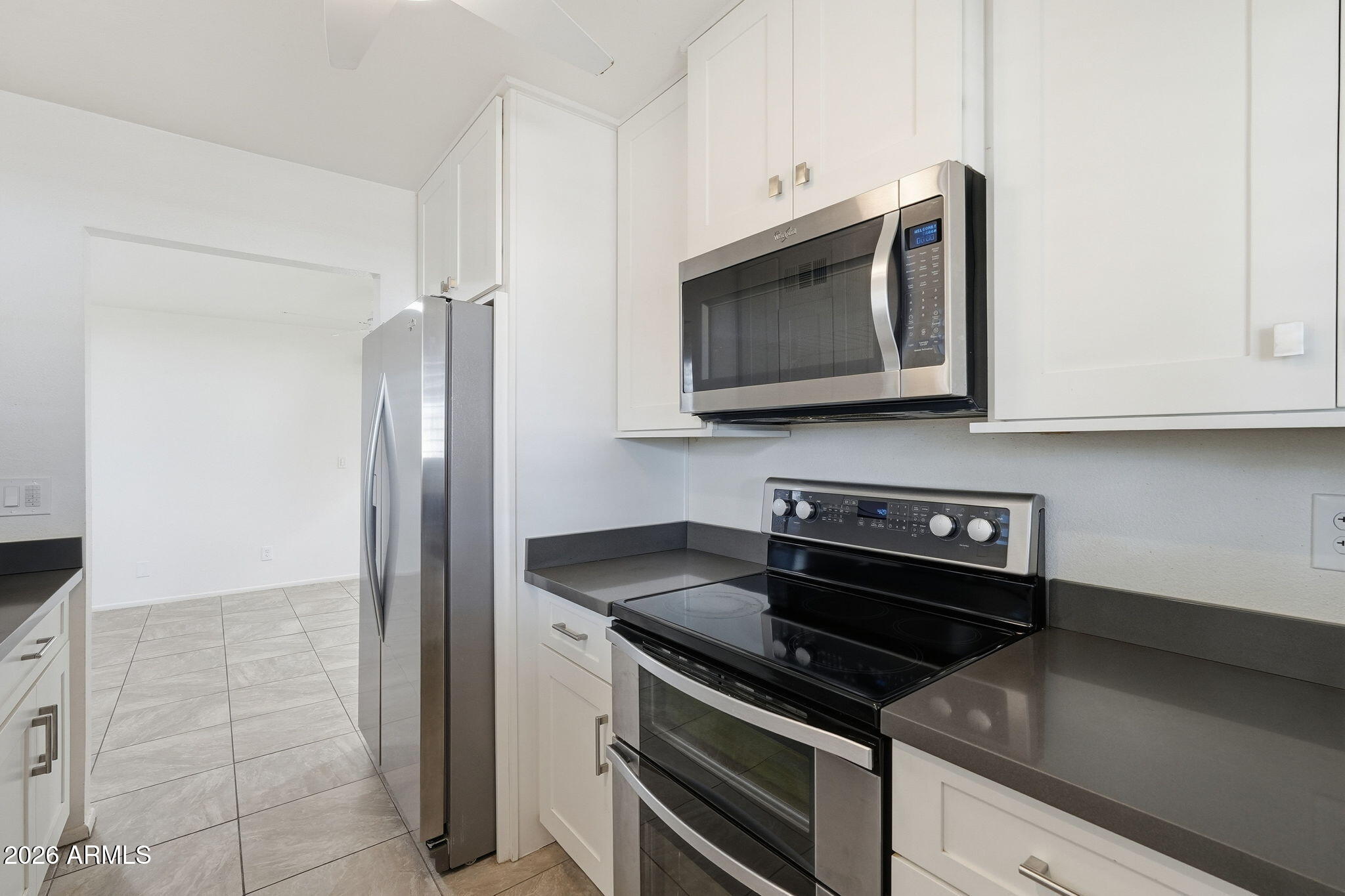 5352 South Country Club Way Tempe, AZ 85283 - Photo 9 of 42 a kitchen with stainless steel appliances granite countertop a stove microwave and refrigerator