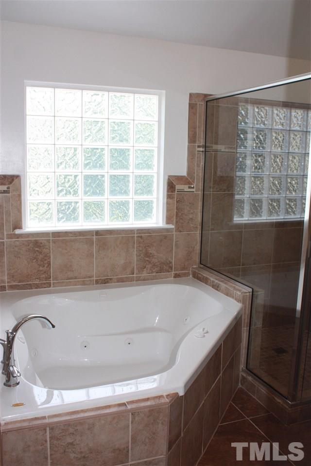 1515 Pebble Ridge Drive Raleigh, NC 27610 - Photo 14 of 17 Updated master bath with oversized tub, tile surround, and LARGE walk in closet!