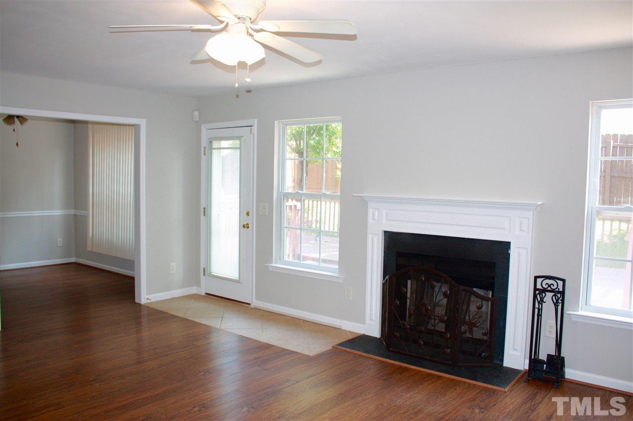 1515 Pebble Ridge Drive Raleigh, NC 27610 - Photo 10 of 17 Large, open family room with woodburning fireplace, and french door leading out to the deck and fenced yard. Open to the dining room and kitchen area with bar space.