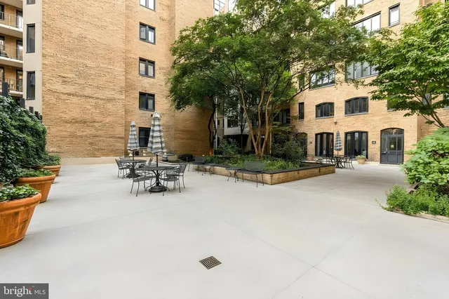 a view of a white house with chairs in patio