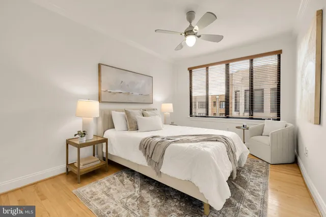 a bedroom with bed and a large window