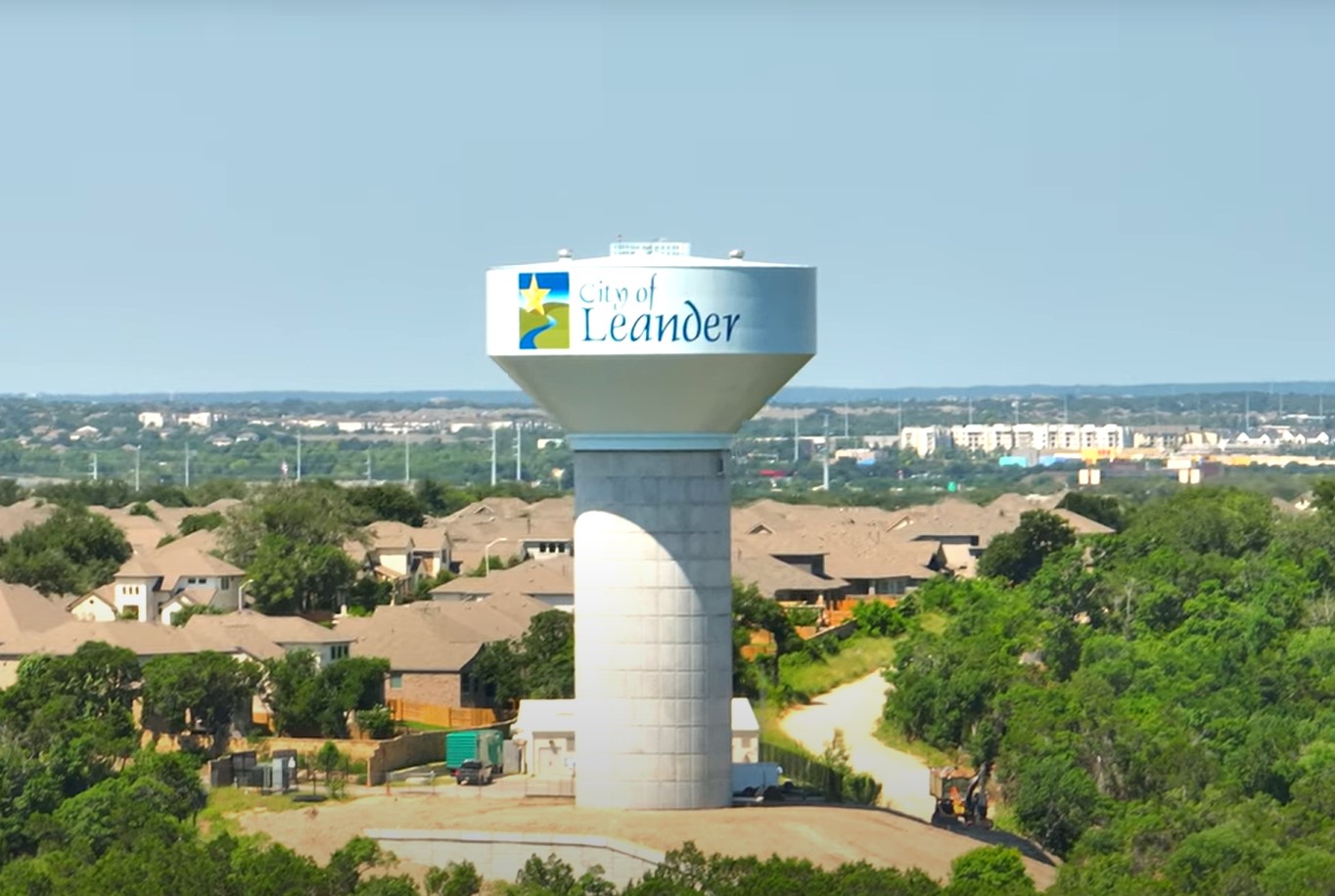 3105 Delaware Street Leander, TX 78641 - Photo 5 of 6 Perched above the tree line, a water tower oversees a growing community of residential rooftops.