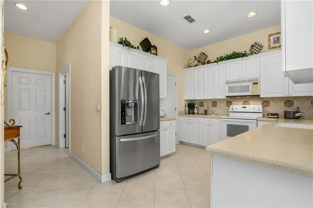 a kitchen with refrigerator cabinets and a sink