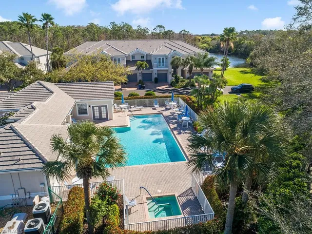 an aerial view of a residential houses with outdoor space