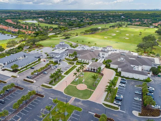 an aerial view of a house with a garden and lake view