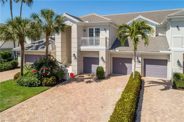 a view of a house with a small yard and potted plants