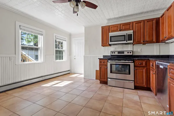 a kitchen with stainless steel appliances granite countertop a stove microwave and sink