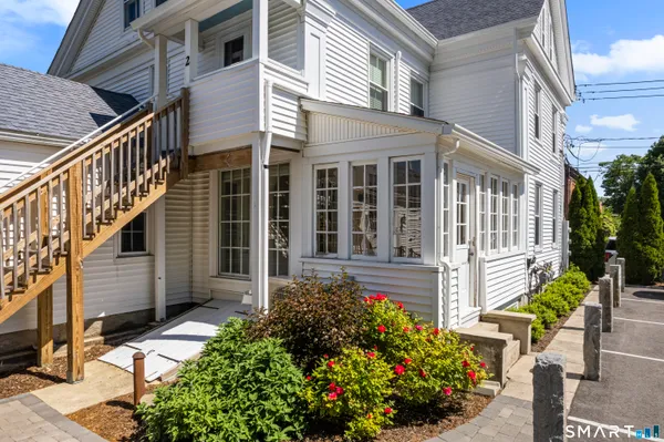 a front view of a house with a garden