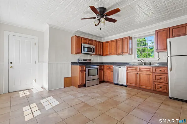 a kitchen with stainless steel appliances a sink and a refrigerator