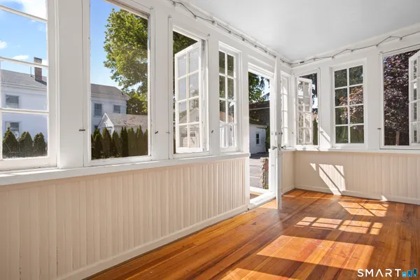 a view of a balcony with wooden floor and outdoor space