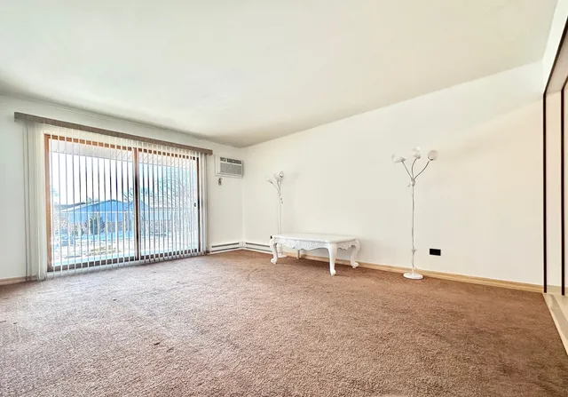a view of empty room with floor to ceiling window