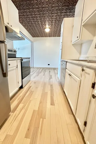 a view of a kitchen with wooden floor