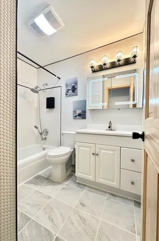 a bathroom with a sink toilet and shower