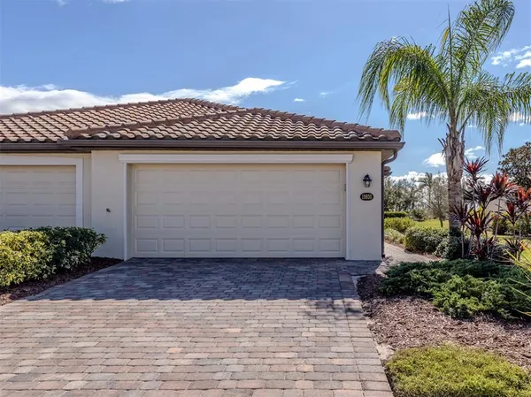 a front view of a house with a yard and a garage