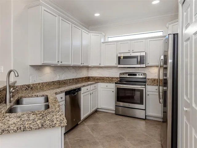 a bathroom with a granite countertop sink a toilet and a mirror