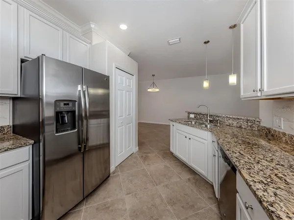 a view of a sink and a dishwasher with wooden floor