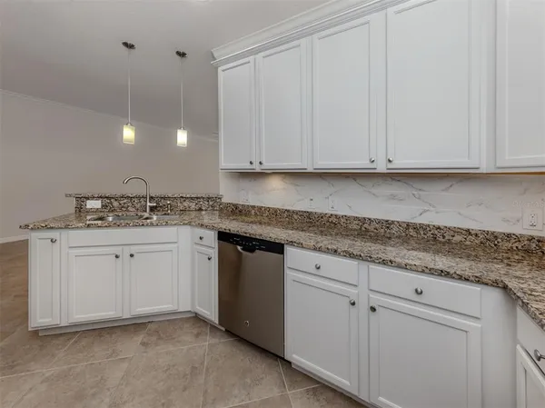 a bathroom with a granite countertop sink a toilet and a mirror