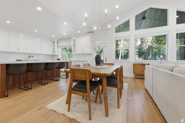 441 South 2080th Street East Springville, UT 84663 - Photo 15 of 64 Spacious open-concept living area featuring light wood-finish flooring, a contemporary chandelier, and high ceilings