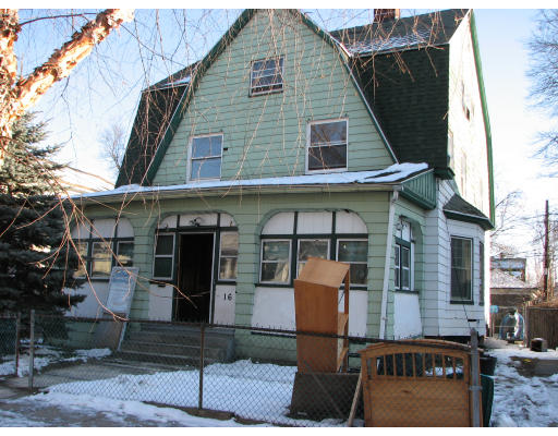 a view of a brick house with large windows