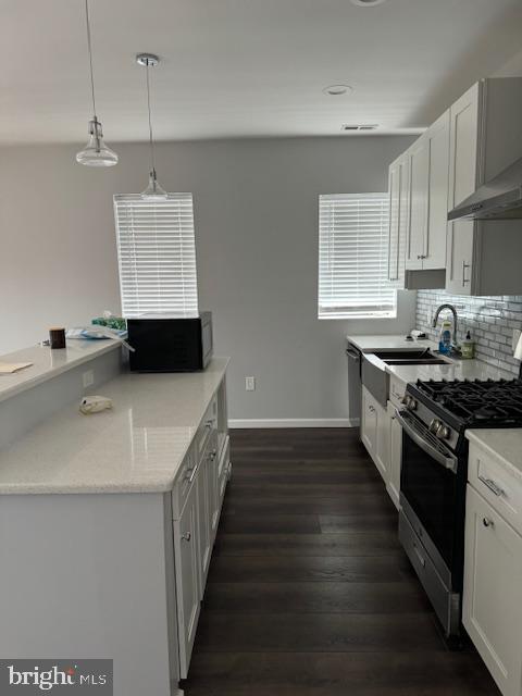 107 West Merchant Street, Unit 2A Audubon, NJ 08106 - Photo 4 of 7 a kitchen with a sink stove top oven and cabinets