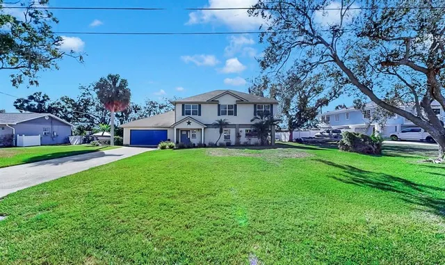 an aerial view of a houses with a lake view