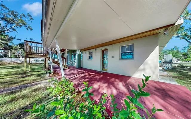 a kitchen with stainless steel appliances granite countertop a refrigerator a sink dishwasher a stove and white countertops with wooden floor