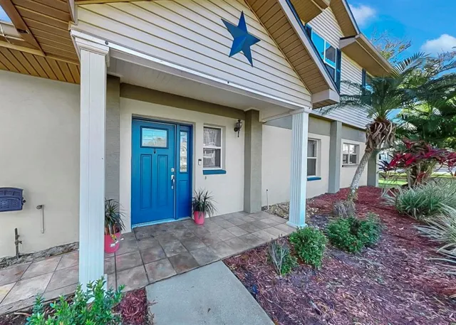 a living room with furniture fireplace and a large window