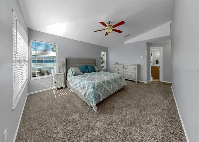 a bathroom with a granite countertop sink a mirror and shower