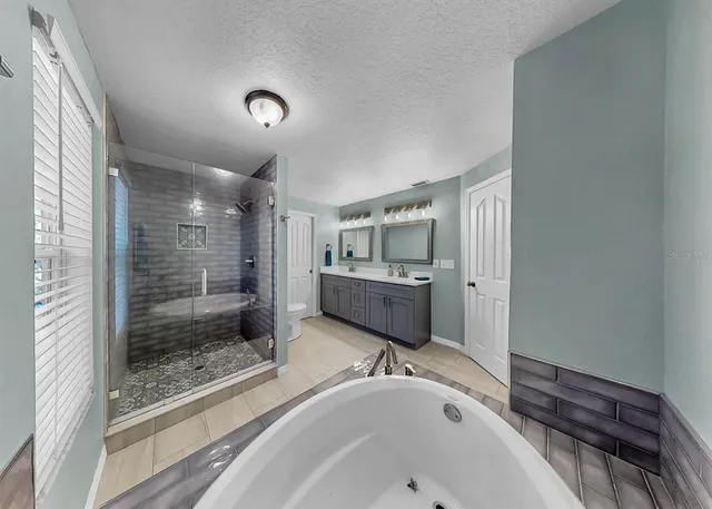 a bathroom with a toilet sink and shower