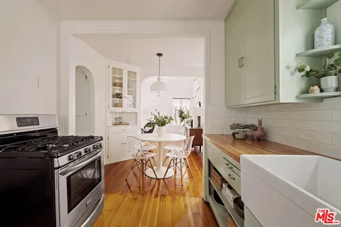 a kitchen with a sink stove and cabinets