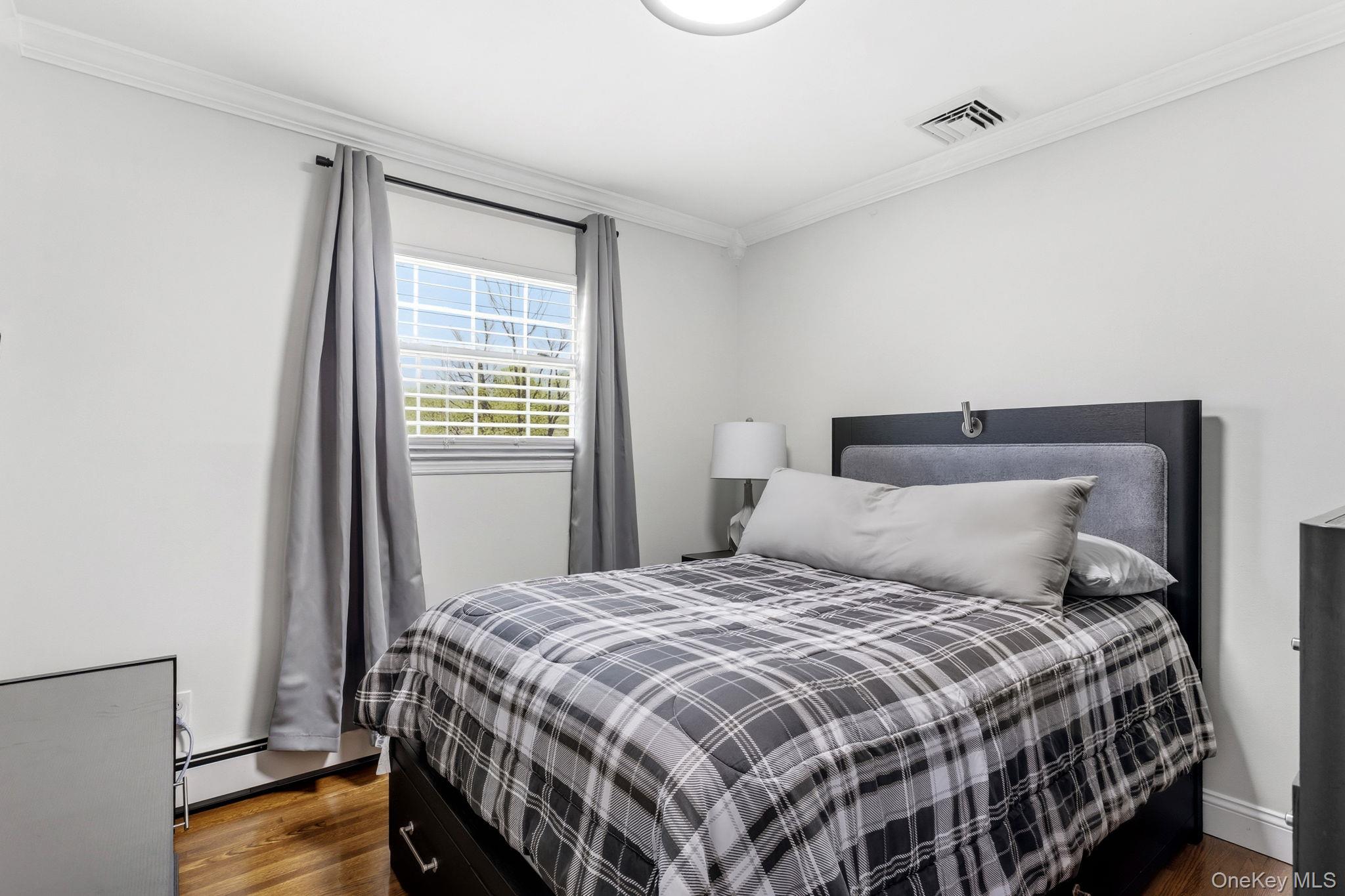 56 Tanager Road Mahopac, NY 10541 - Photo 18 of 30 a bedroom with a bed and wooden floor