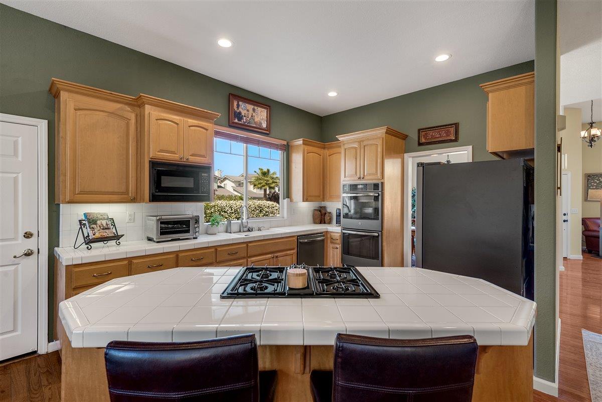 1416 Casablanca Circle Gilroy, CA 95020 - Photo 12 of 32 a kitchen with stainless steel appliances a stove a sink a refrigerator and cabinets