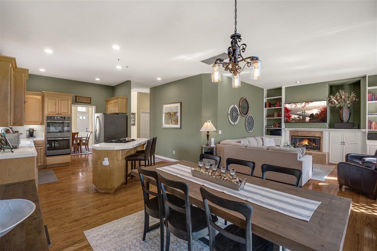 1416 Casablanca Circle Gilroy, CA 95020 - Photo 13 of 32 a living room with furniture a chandelier and a dining table
