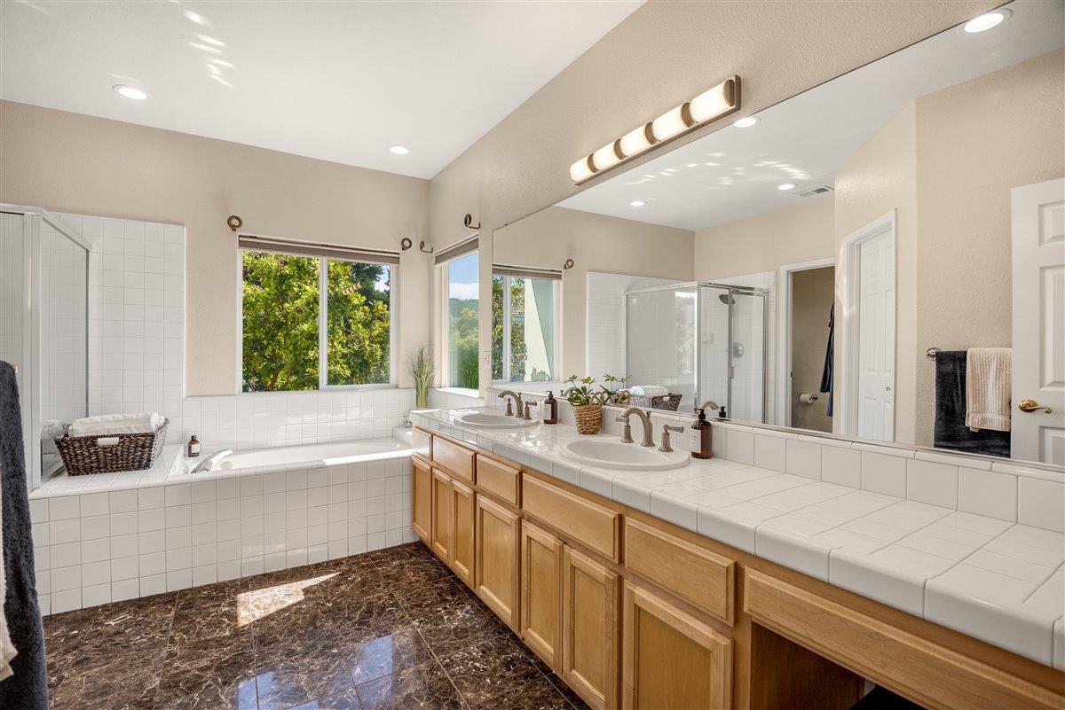 1416 Casablanca Circle Gilroy, CA 95020 - Photo 18 of 32 a bathroom with a tub a sink and a large window