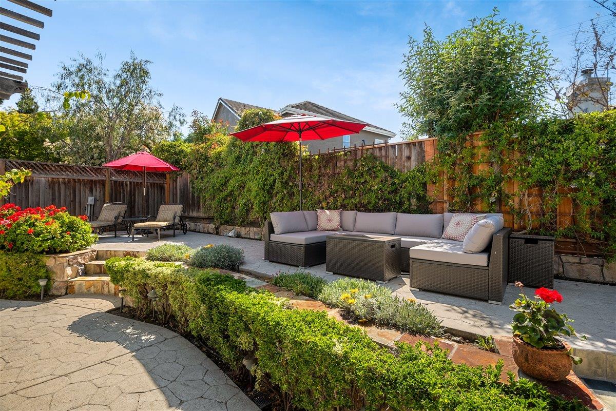 1416 Casablanca Circle Gilroy, CA 95020 - Photo 28 of 32 a view of a patio with couches and a table and chairs under an umbrella