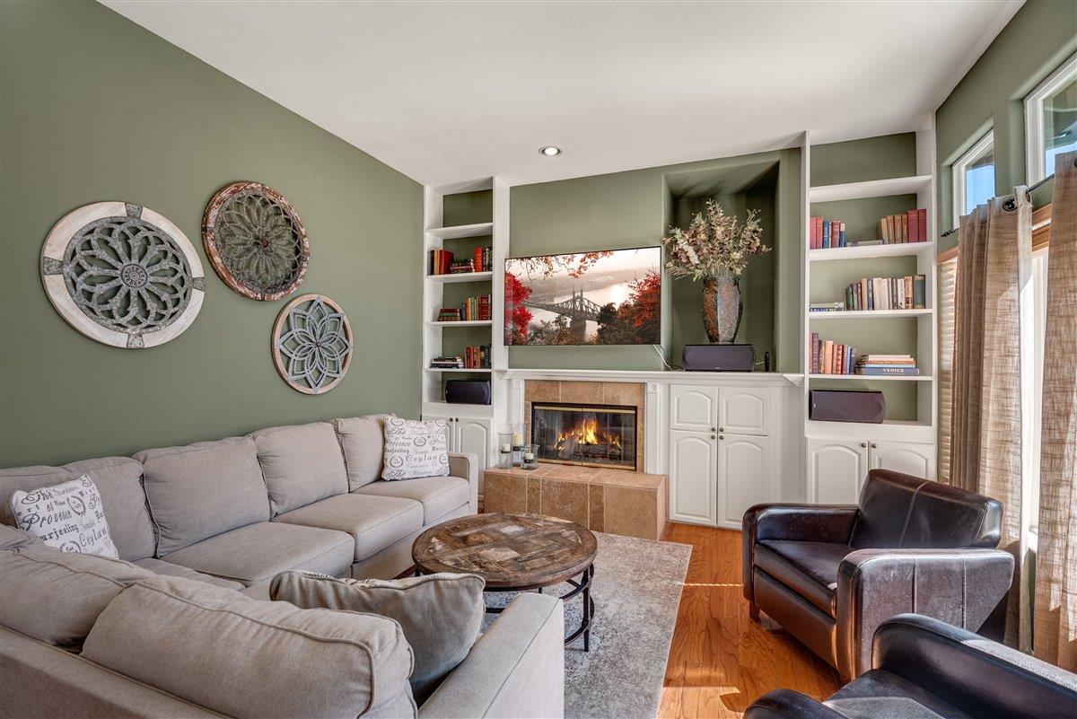 1416 Casablanca Circle Gilroy, CA 95020 - Photo 5 of 32 a living room with furniture a fireplace and a flat screen tv