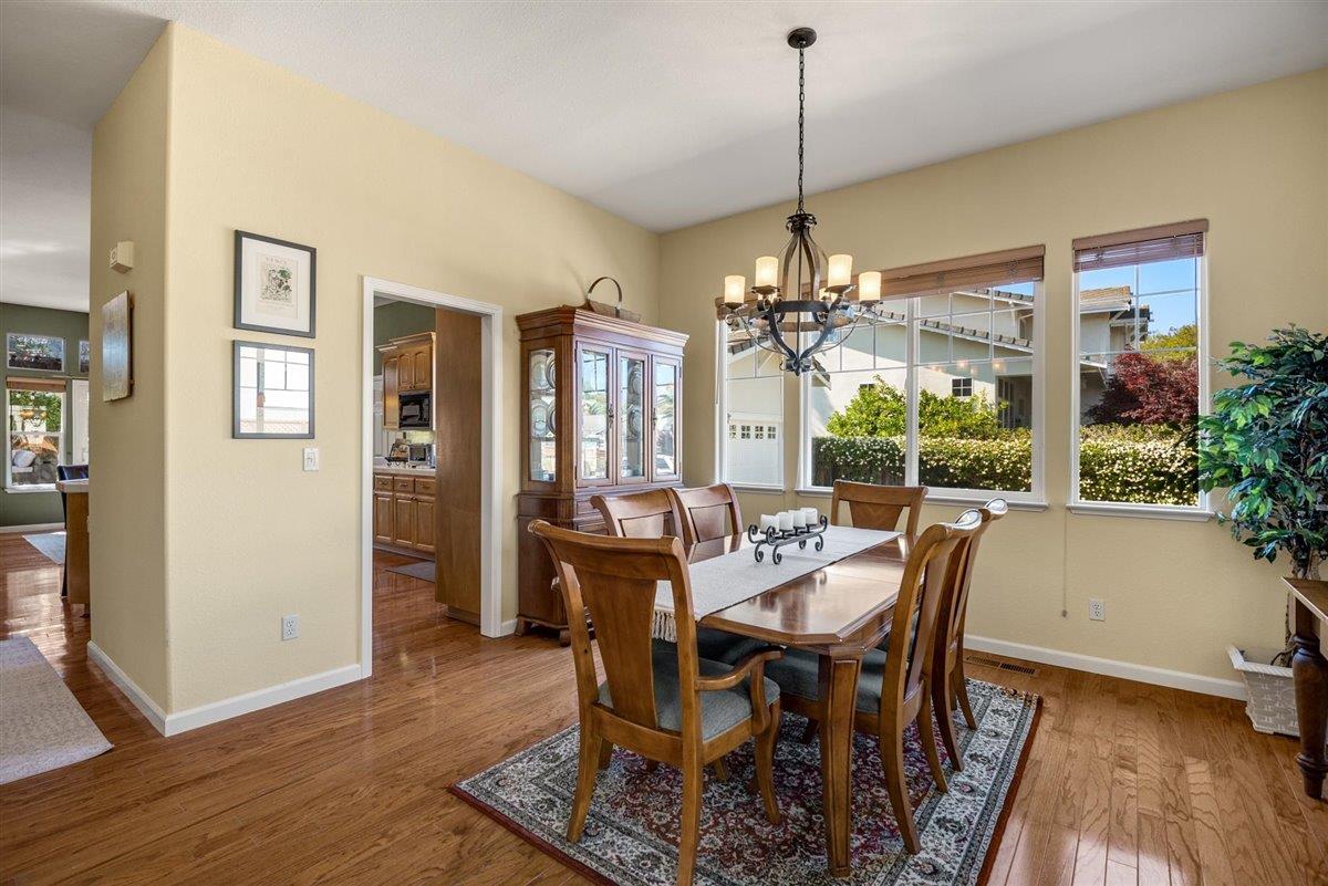 1416 Casablanca Circle Gilroy, CA 95020 - Photo 8 of 32 a dining room with furniture a chandelier and wooden floor