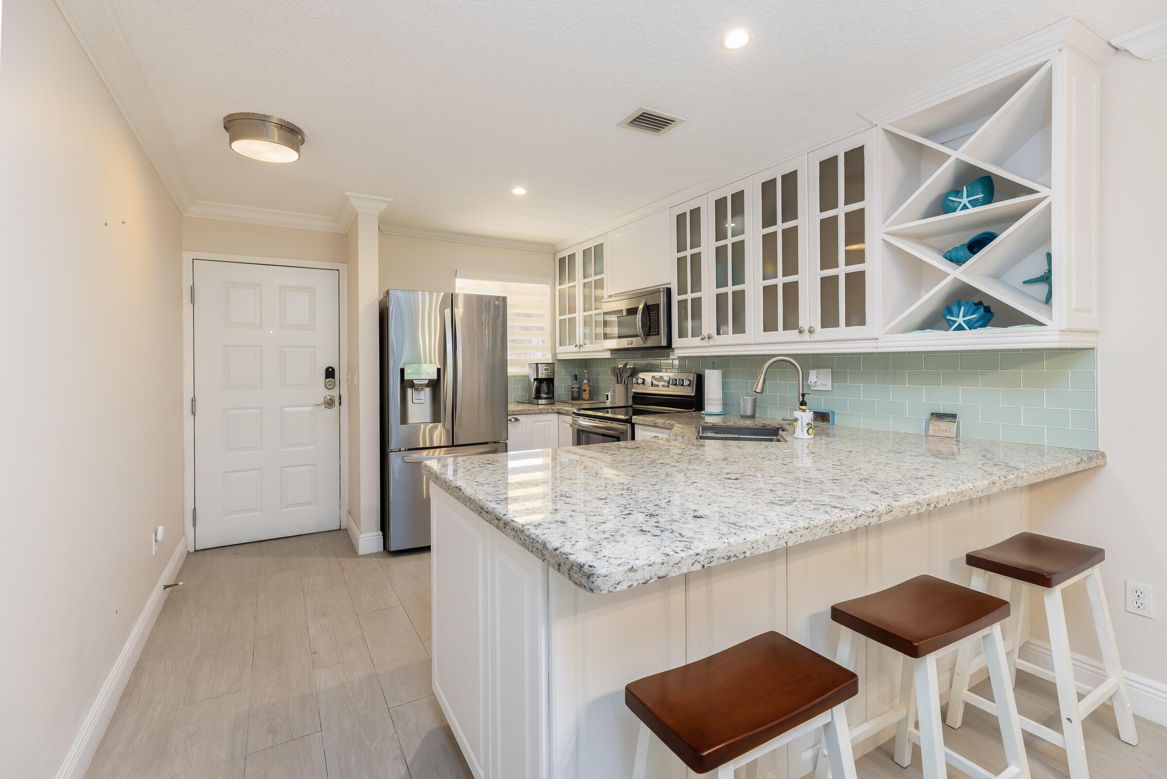 98222 Windward Avenue Key Largo, FL 33037 - Photo 13 of 41 a kitchen with stainless steel appliances granite countertop a sink and a refrigerator