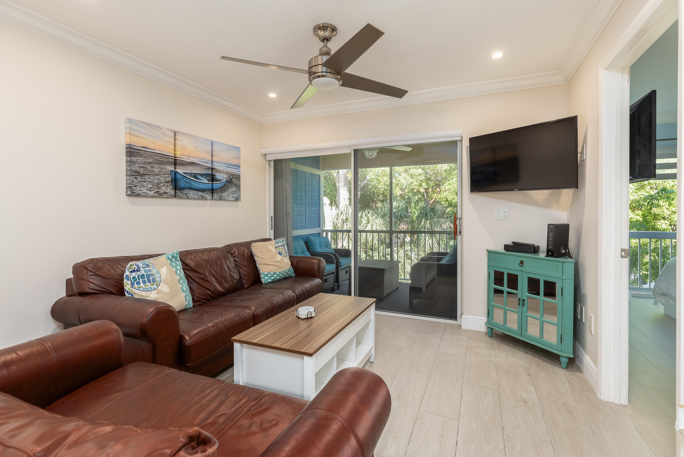 98222 Windward Avenue Key Largo, FL 33037 - Photo 2 of 41 a living room with furniture a flat screen tv and a floor to ceiling window