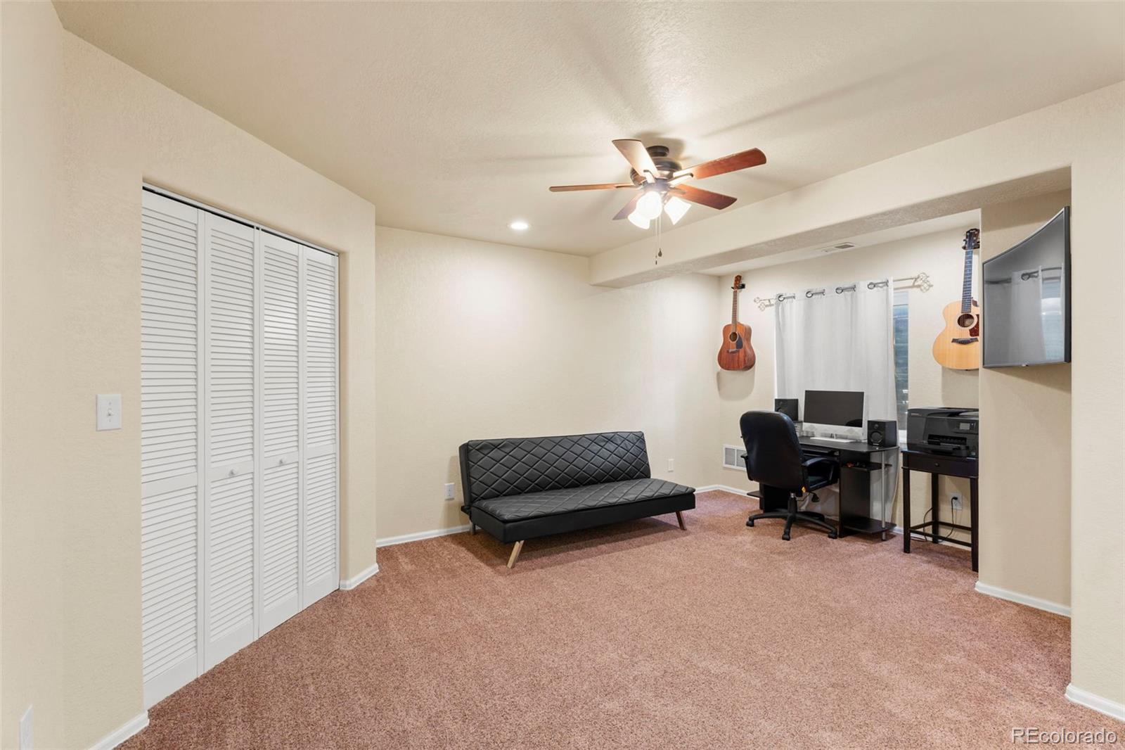 4651 Dancing Rain Way Colorado Springs, CO 80911 - Photo 13 of 32 a living room with furniture and a chandelier