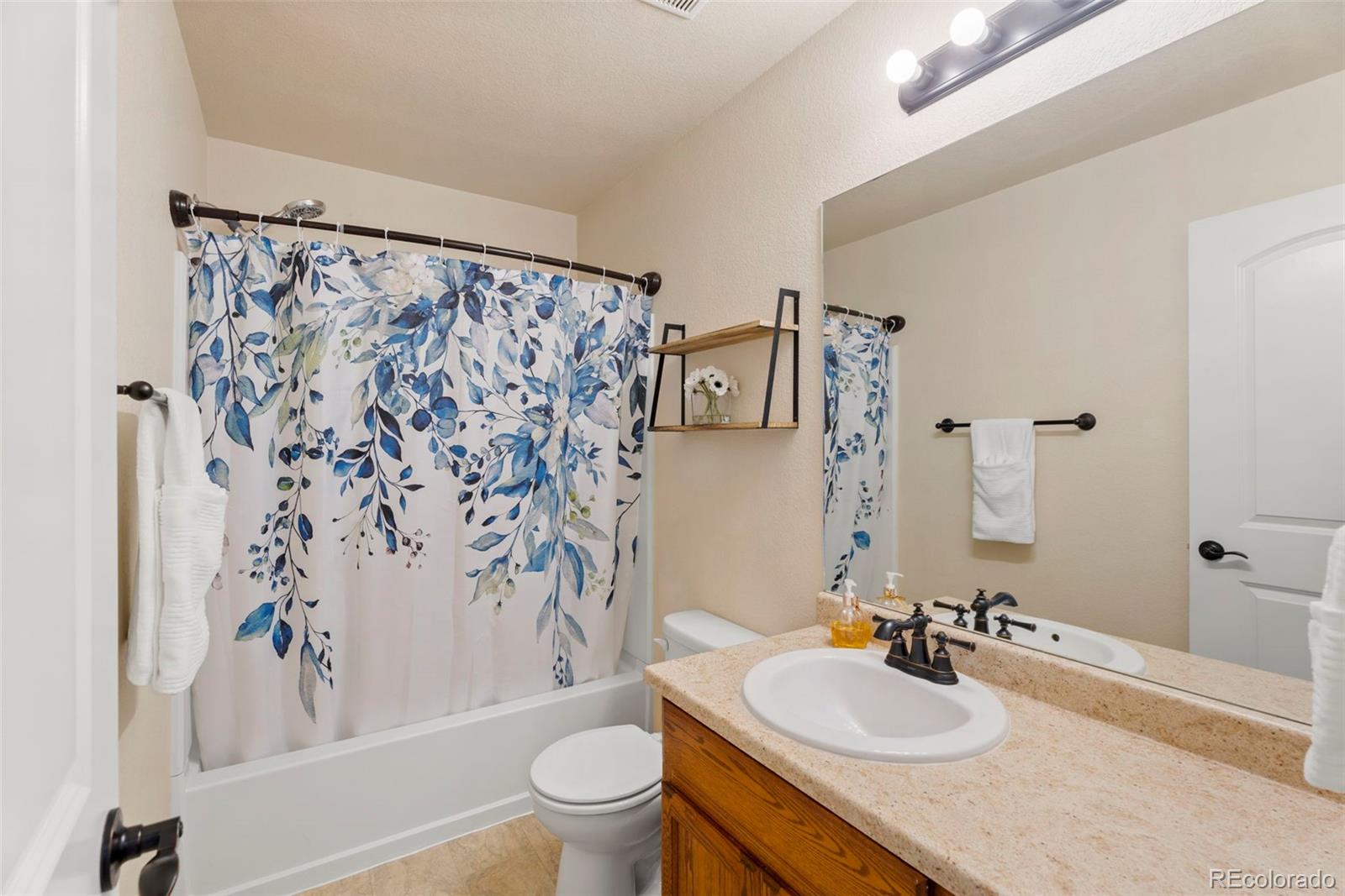 4651 Dancing Rain Way Colorado Springs, CO 80911 - Photo 15 of 32 a bathroom with a sink toilet and shower