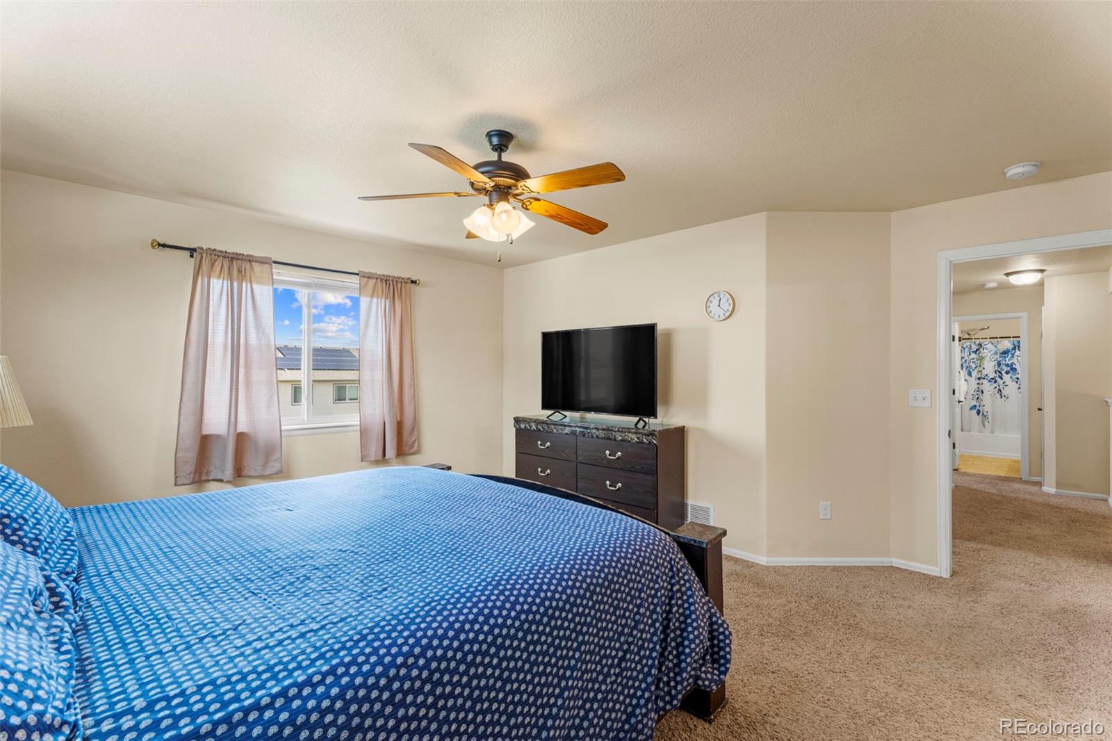 4651 Dancing Rain Way Colorado Springs, CO 80911 - Photo 20 of 32 a bedroom with a bed and a flat screen tv